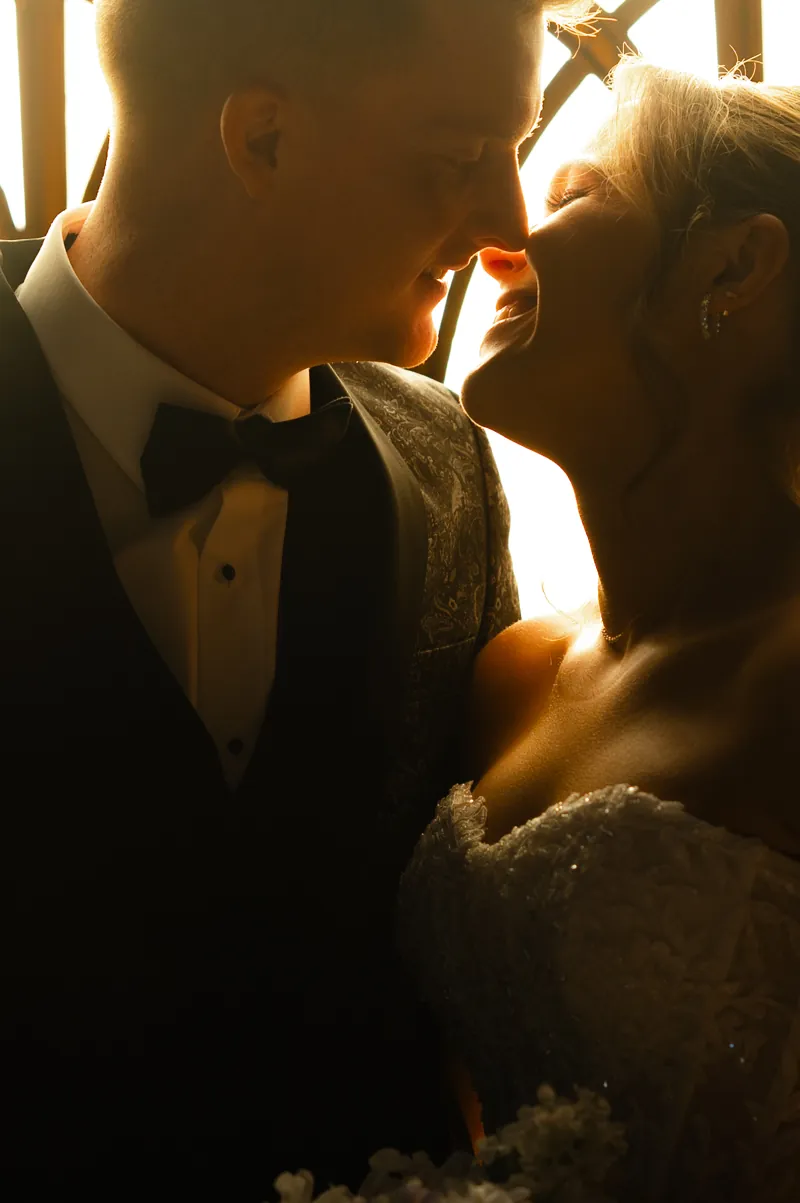 Pearson and Emma sharing a close moment, backlit by warm window light
